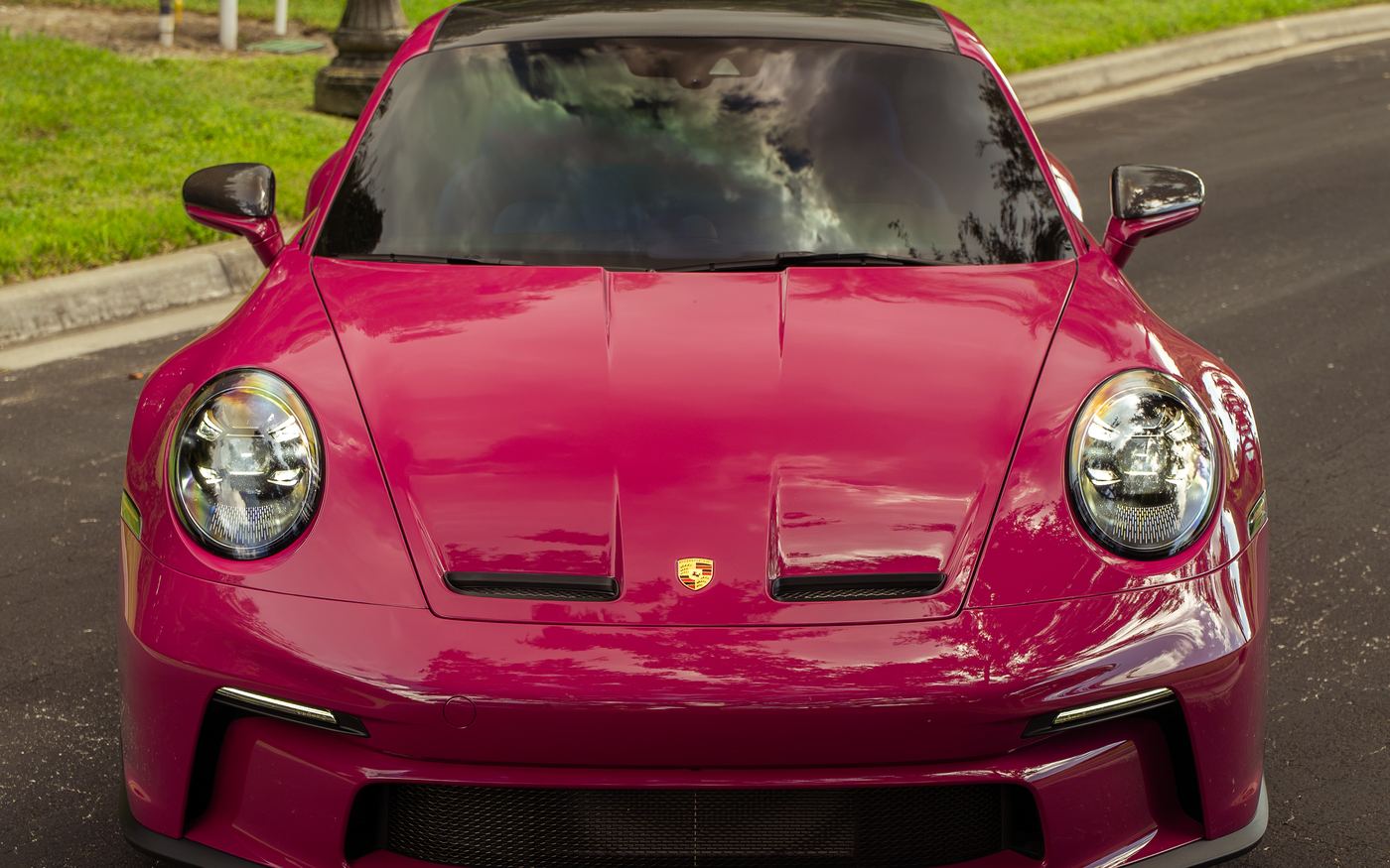 GT3 Touring front three-quarter on a tree-lined road
